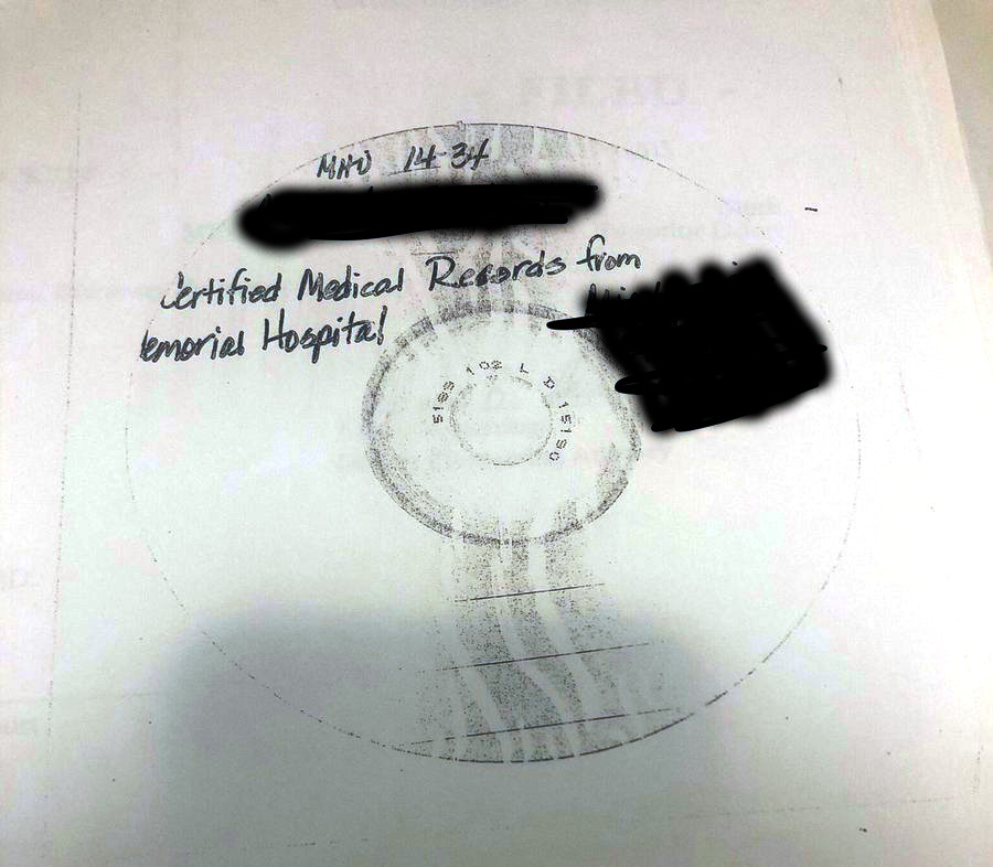 A photocopy of a CD with personal information blacked out