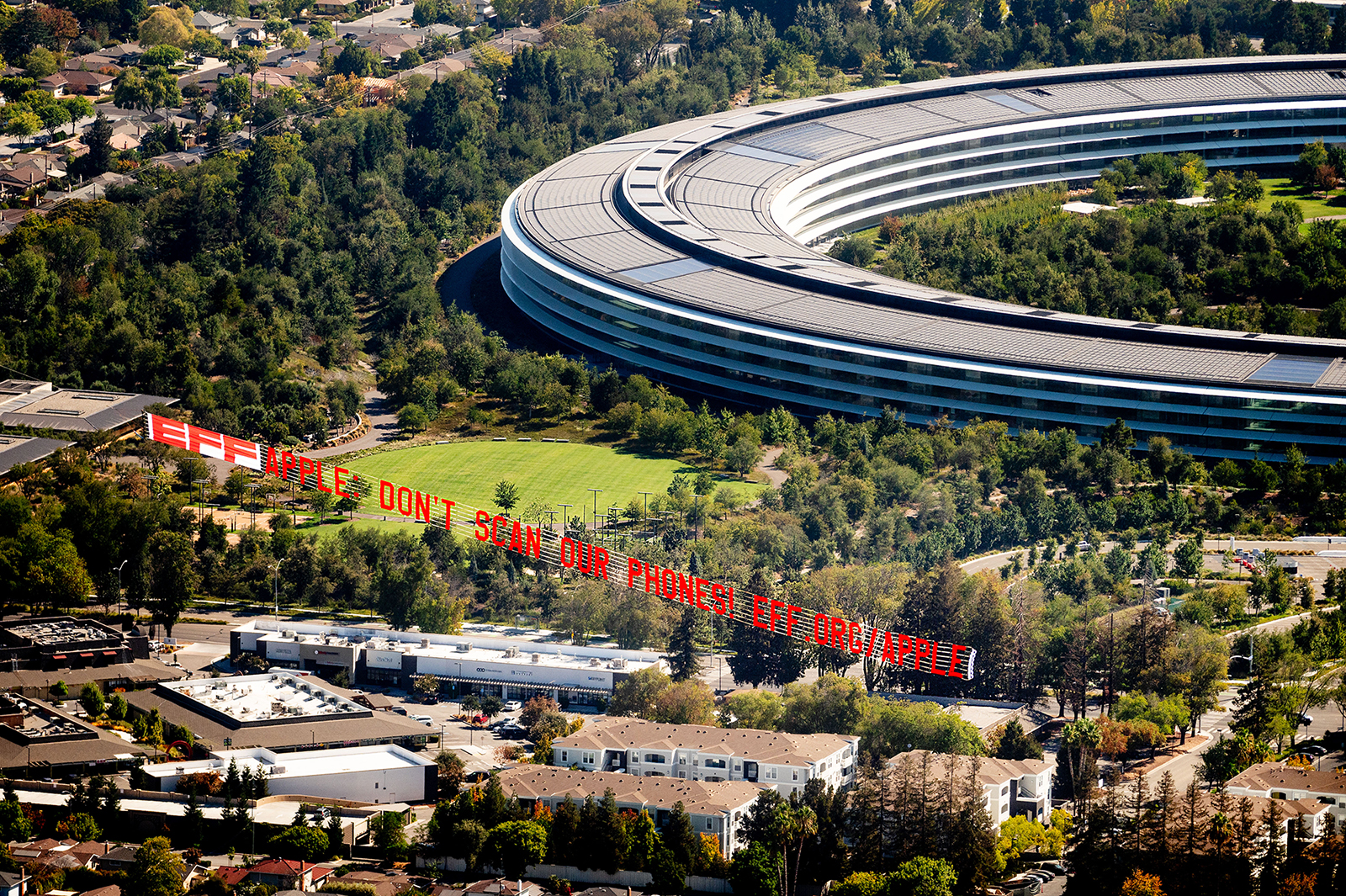 A plane flies over Apple's HQ with a banner