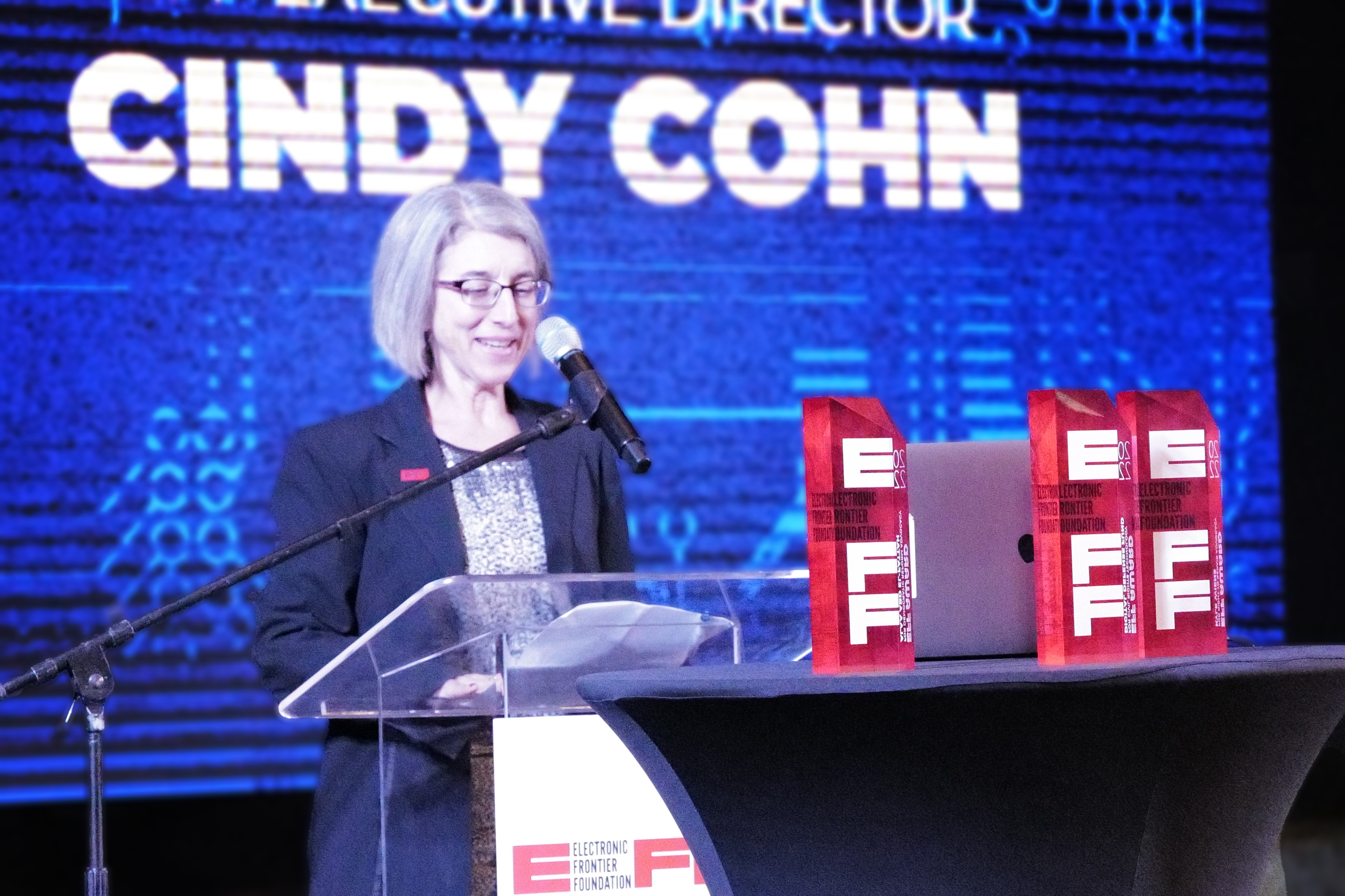 Cindy Cohn speaking at the podium for the EFF Awards 2022