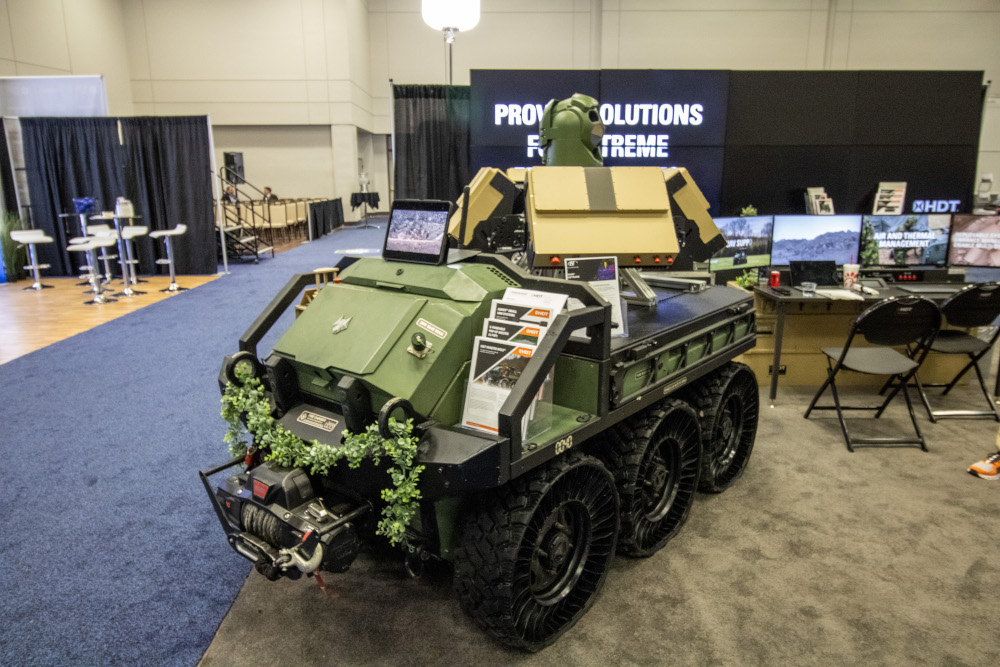 A heavy duty off-road vehicle with a surveillance camera at a border expo.