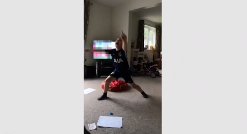 Child dancing in front of blurred television